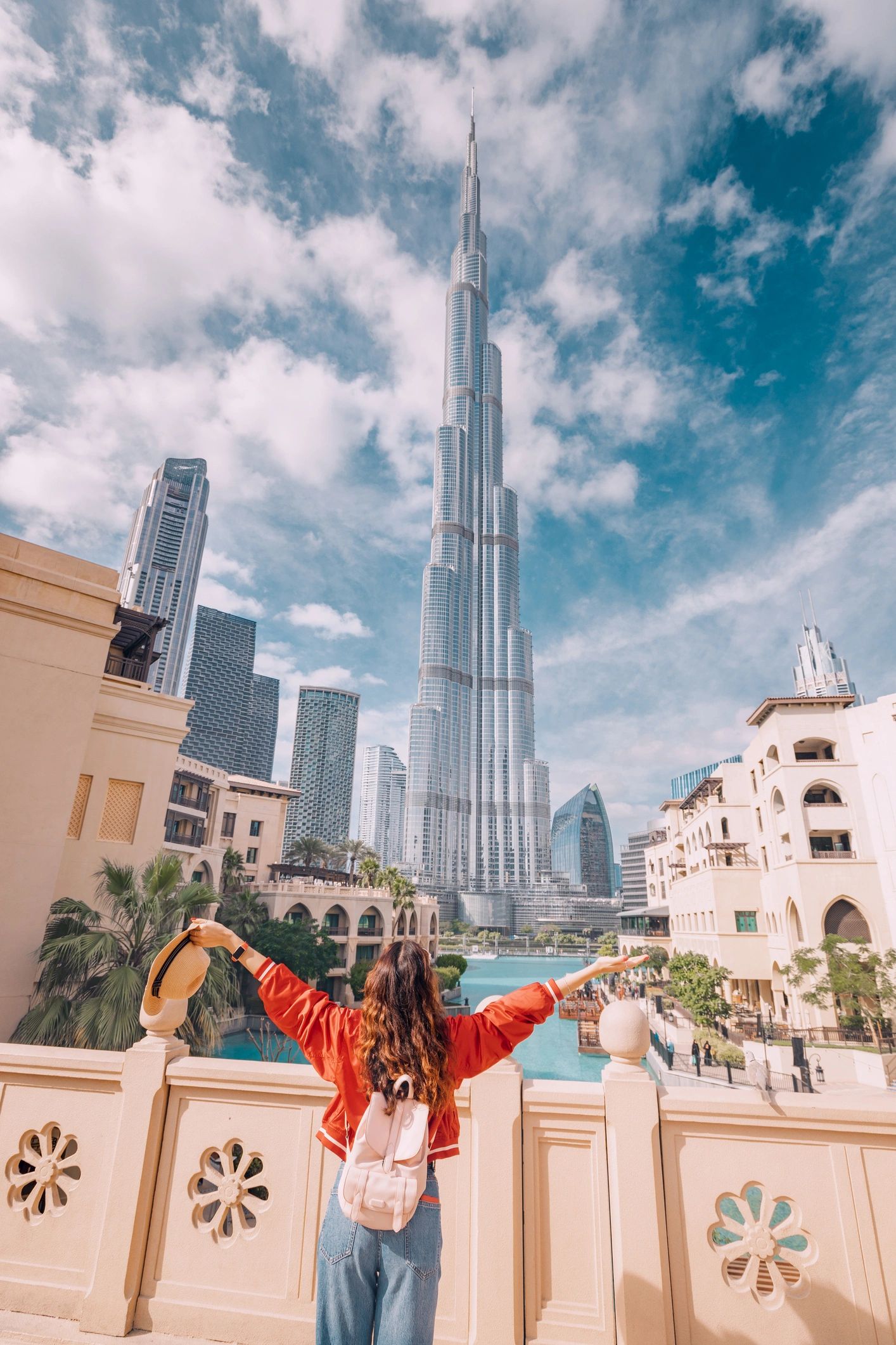 Happy girl arms are outstretched, as she embracing the beauty of Dubai.